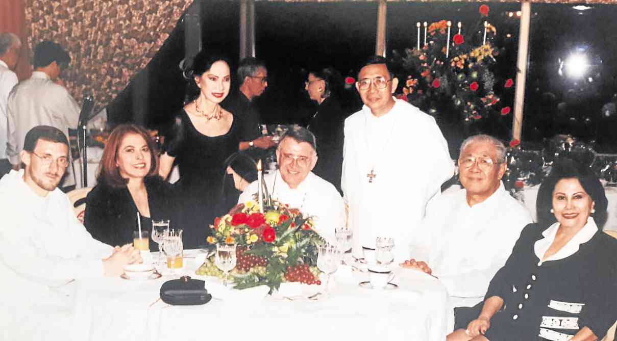 MELDY Cojuangco (standing) at the dinner she hosted in honor of the abbot of Montserrat, with (seated from left) Fr. Joandrew, OSB, Stella Araneta, Father Abbot Sebastia Bardolet, OSB, Father Abbot Eduardo Africa, OSB (standing), then Senator Vicente Paterno, and Dra. Loi Ejercito
