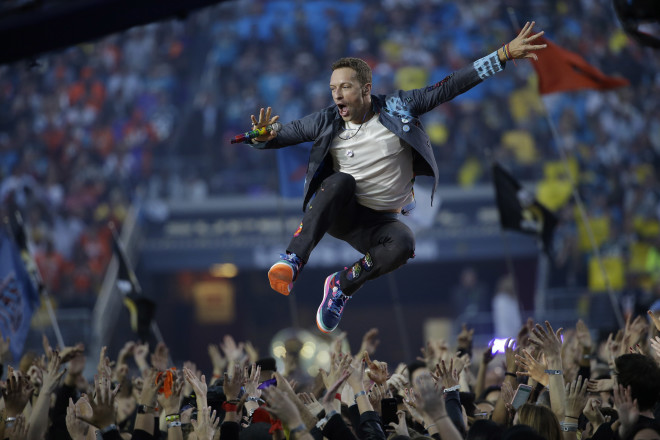 FILE - In this Feb. 7, 2016 file photo, Coldplay singer Chris Martin performs during halftime of the NFL Super Bowl 50 football game, in Santa Clara, Calif. On Friday, Aug. 19, 2016, Coldplay published the video of its single, “A Head Full Of Dreams”, shot in Mexico City. The band is nominated in three categories of the MTV VMAs, held on Aug. 28. (AP Photo/Marcio Jose Sanchez, File)