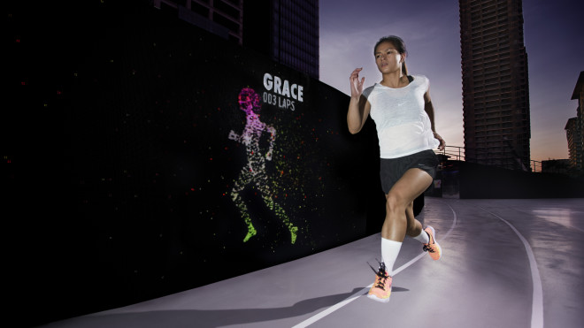 Nike Run Club Coach Ian Banzon outpacing her avatar at the Unlimited Stadium