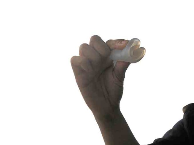 Tangonan demonstrates a fold to insert the menstrual cup. This one is the so-called C-fold.