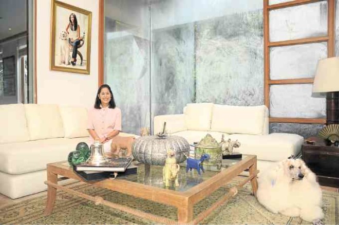 IN THE living room of her Forbes Park home. Behind her is a portrait of younger daughter Michaela by Mia Herbosa.