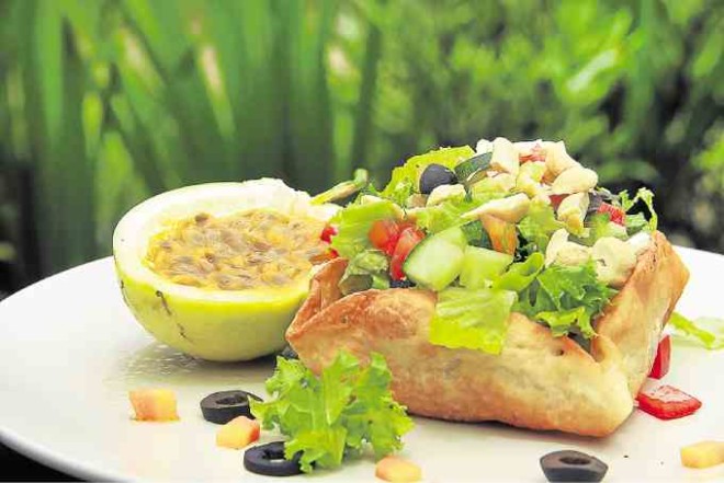SALAD on a taco shell with passion fruit, made with Nurture Farm’s homegrown superfoods