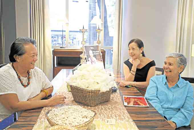 ADELAIDA Lim, Louie Locsin and Maribel Ongpin in front of baskets of cotton seeds (foreground) and raw cotton PHOTOS BY KIMBERLY DELA CRUZ