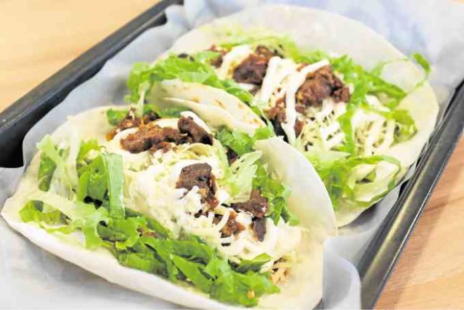 K-Taco, soft flour tortilla filledwith lettuce, kimchi, sour cream, cheese and meat of choice —PHOTOS BY ALEXIS CORPUZ