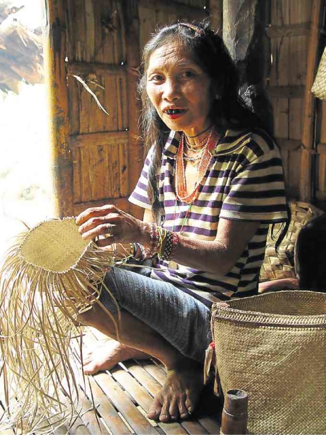 A Hanunuo Mangyan weaving a basket