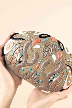 Daisy is a hand carved and hand-painted wood minaudière