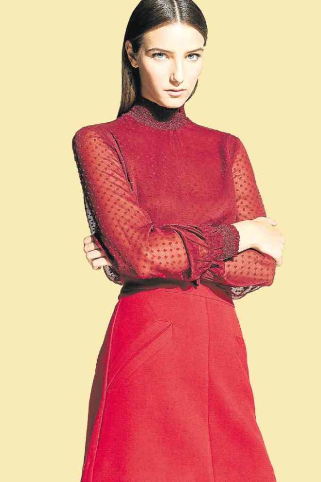 Seeing red. Sheer funnel neck on cuffed long-sleeve blouse paired with A-line skirt