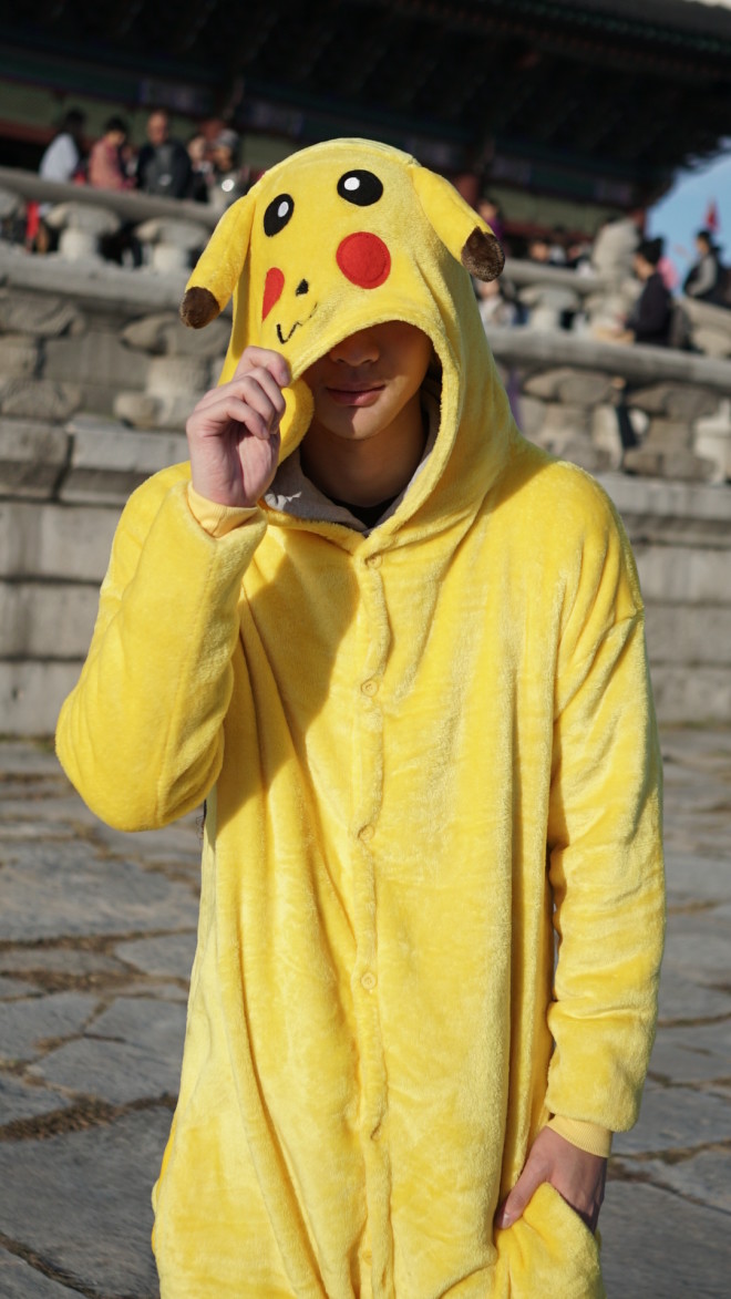 Richard Juan in Korea wearing his “Pikachu” onesie