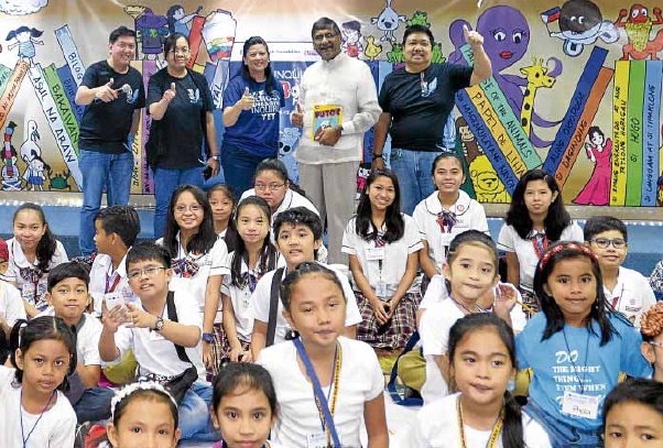 BOOKLOVERS ALL Inquirer president and CEO Sandy Prieto-Romualdez and British Ambassador Asif Ahmad (center) join young book lovers on the second day of the Read-Along Festival.