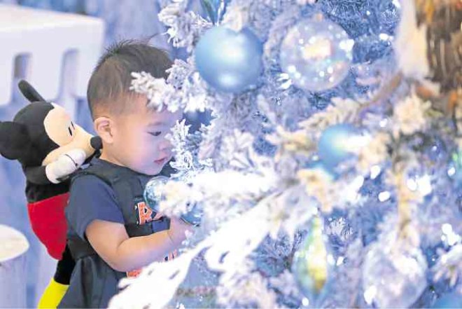 Little shopper gets engrossed studying the Christmas trimming. PHOTOS BY KIMBERLY DELA CRUZ