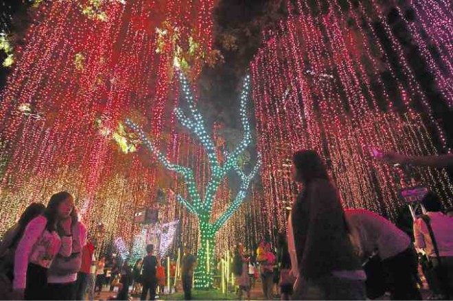 Ayala Triangle Gardens’ "Festival of Lights" attracts thousands of Filipinos each year with its magical light show and Christmas sounds. —ARNOLD ALMACEN