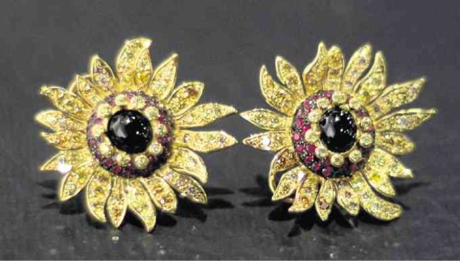 Hans Brumann's earrings are a take on Vincent Van Gogh's "Sunflowers." Golden and white diamonds, onyx and rubies set in yellow gold —PHOTOS BY ARNOLDALMACEN