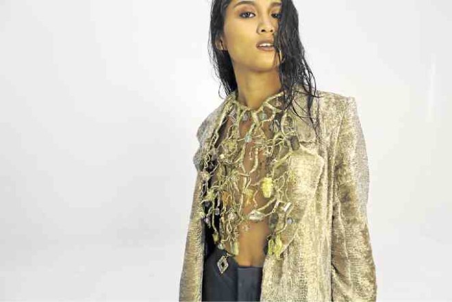 Jeweled bib over opera-length coat of 24k gold leaf on camel hair fiber blend