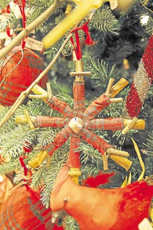 Ornament made of wood pieces wrapped in plaid fabric