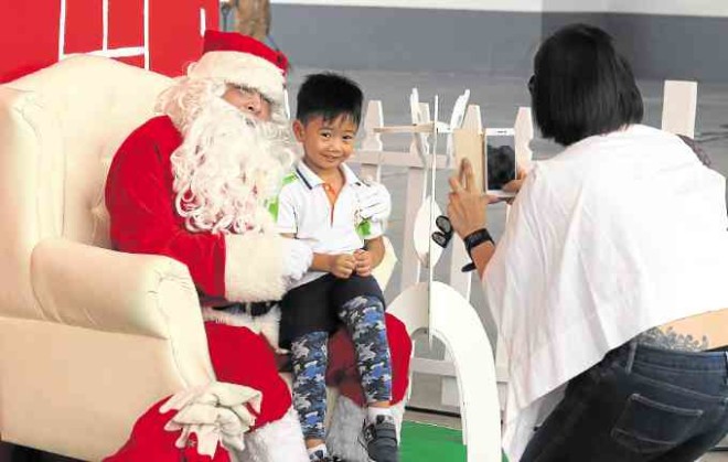 A holly jolly Christmas. Children enthusiastically flocked the Circuit Makati Bazaar 2016 for the chance to posewith Santa Claus.