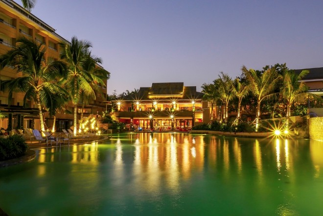 The resort's main building at dusk provides couples a romantic island setting.