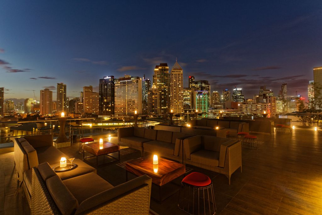 The Makati skyline at dusk forms a dramatic backdrop to cocktails at Mireio