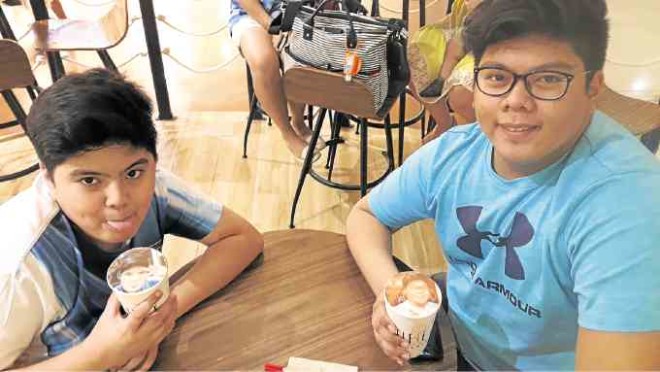 Kids posewith their Selfie Signature Freeze drinks at Selfie Café.