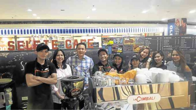 Pamela Felizarta (second from left) and Dennis Chiu (third from left) with Selfie Café’s staff —PHOTOS BY YARA LUKMAN