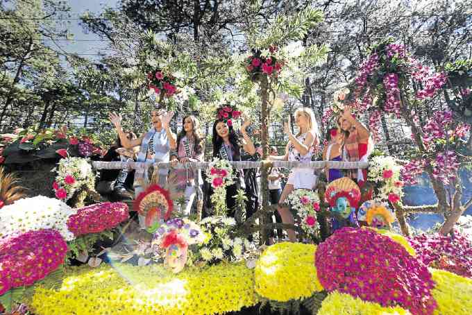 FLOAT OF FLOWERS AND MASKS Several Miss Universe candidates ride on a float adorned with flowers and masks representing the Visayas during a parade on Session Road in Baguio City. The three other floats bearing the other beauties, including reigning Miss Universe Pia Alonzo Wurtzbach, represented Luzon, Mindanao and the sponsoring Baguio Country Club.  —EV ESPIRITU