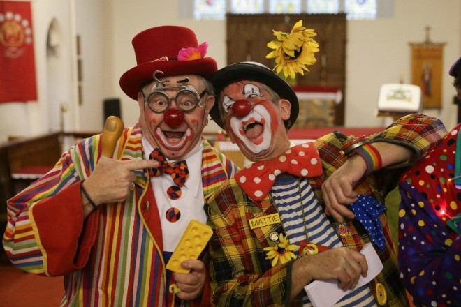 Clowns perform ahead of the annual Grimaldi Memorial Service at the All Saints church in east London on February 5, 2017.  The service takes place to celebrate the father of modern clowning, Joseph Grimaldi, who died in 1837.  / AFP PHOTO / Daniel LEAL-OLIVAS