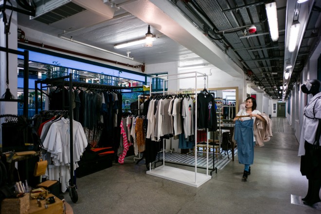 In this picture taken on March 17, 2017, a customer browses clothes in an independant fashion shop in Hong Kong. Soulless supermalls housing luxury labels, traditional suit tailors, and markets full of cheap designer knock-offs, Hong Kong's flaccid fashion scene has long struggled to compete with the sartorial cool of Tokyo's Harajuku, or the street style of Hongdae in Seoul. But a new generation of independent designers in Hong Kong is changing all that with creations that are putting the city on the international fashion map.  / AFP PHOTO / Anthony WALLACE / TO GO WITH AFP STORY: HongKong-fashion-design-economy-lifestyle, FEATURE by Liz THOMAS