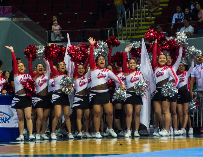 Junior division first runner-up San Beda College Alabang’s cheerleaders wave to the fans. —PHOTO BY GERALD REBULADO