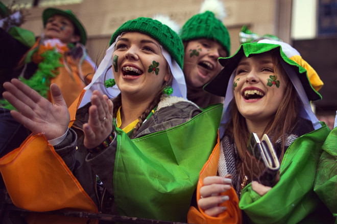 Spectators watch as revelers march up Fifth Avenue during the St. Patrick's Day Parade, Friday, March 17, 2017, in New York.  New York City was awash in green and Irish pride  as throngs celebrated at the annual St. Patrick’s Day Parade in Manhattan. (AP Photo/Andres Kudacki)