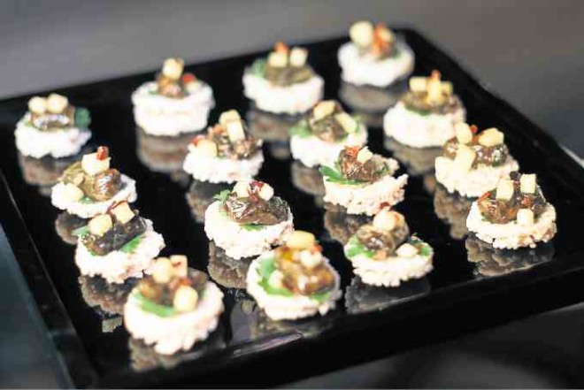 Rice Cracker with Minced Pork and Prawnwrapped in pickled mustard green leaves by Bo Songvisava