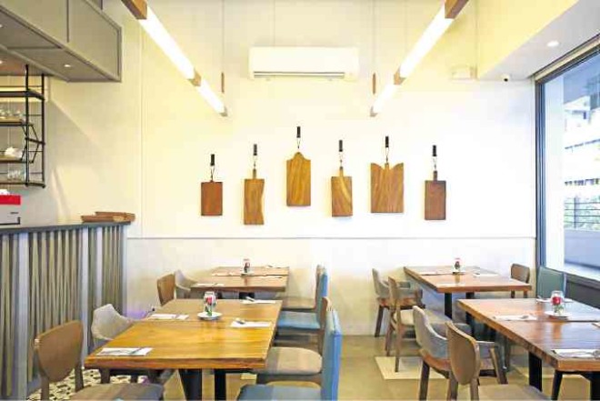 Heavy chopping boards are displayed like artwork on thewall at Char.