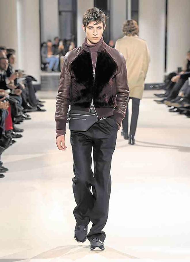 Blouson with ribbing in winered cable-effect sheepskin; turtleneck pullover in string six-ply cashmere; one-pleat large trousers in black cotton gabardine