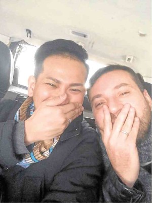 Lourd Ramos (left) and Medhi Moussaui show off their rings after getting hitched in New York. 