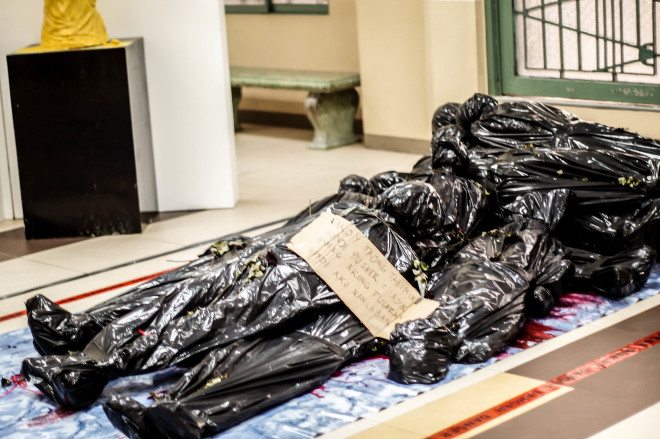 Dummies stuffed in trash bags symbolize how life can go from being precious to wasted.