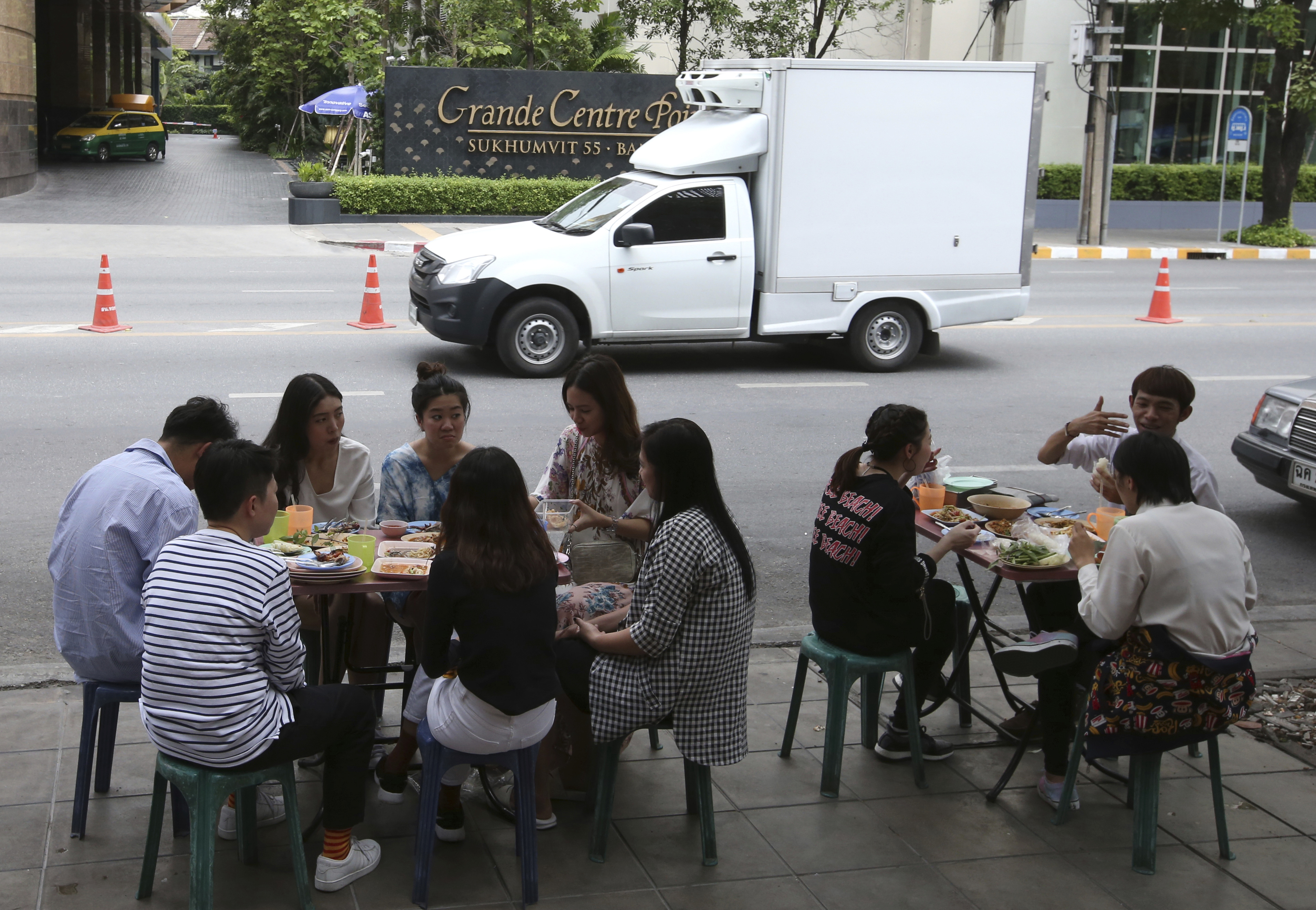 In this April 7, 2017 photo, people have their lunch at a street food shop on Thonglor road in Bangkok, Thailand. Officials see street food as an illegal nuisance and have warned hawkers in Thonglor to clear out by April 17. Efforts by authorities in military-ruled Thailand to impose order on the chaotic capital city have a fresh target: cheap and tasty pad thai. The latest crackdown by Bangkok city officials is going after the vendors whose carts selling everything from Thailand’s signature noodles to spicy tom yum goong soup have become institutions on the capital’s hot and humid sidewalks. (AP Photo/Sakchai Lalit)