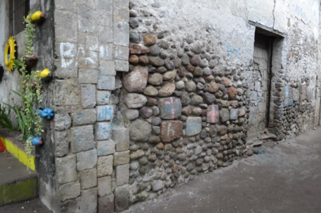 Back wall of the old school building showing different stone- construction materials