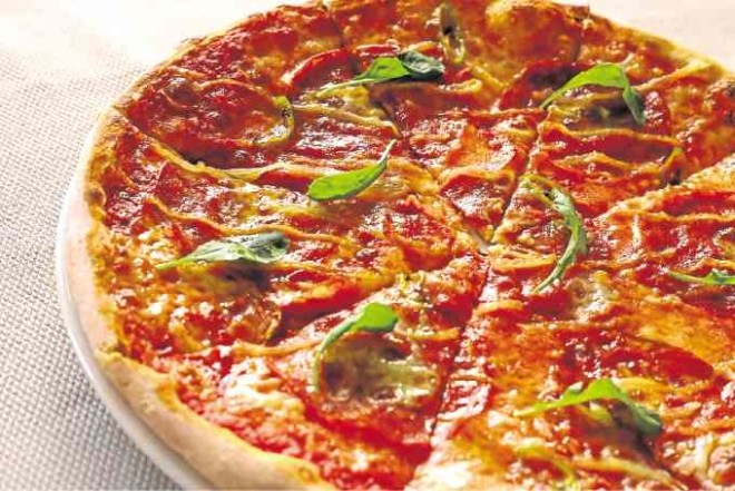 Pizza Edi: tomato sauce, mozzarella, pepperoni, onions and chili peppers on a thin crust