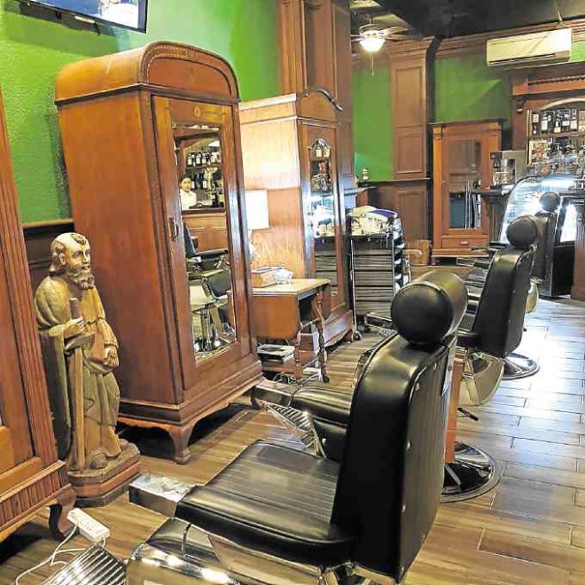 The snazzy interiors of Il Capo barbershop in Lipa, Batangas, feature Filipino antique cabinets and “rebulto.”