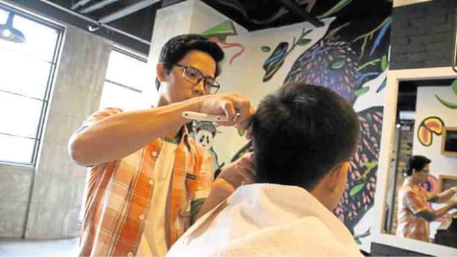 Barber in action at The Urban Barbershop