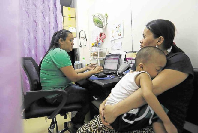 COUNSELINGA young mother gets family planning advice from registered midwife Suzette Reyes at a women’s health NGO.