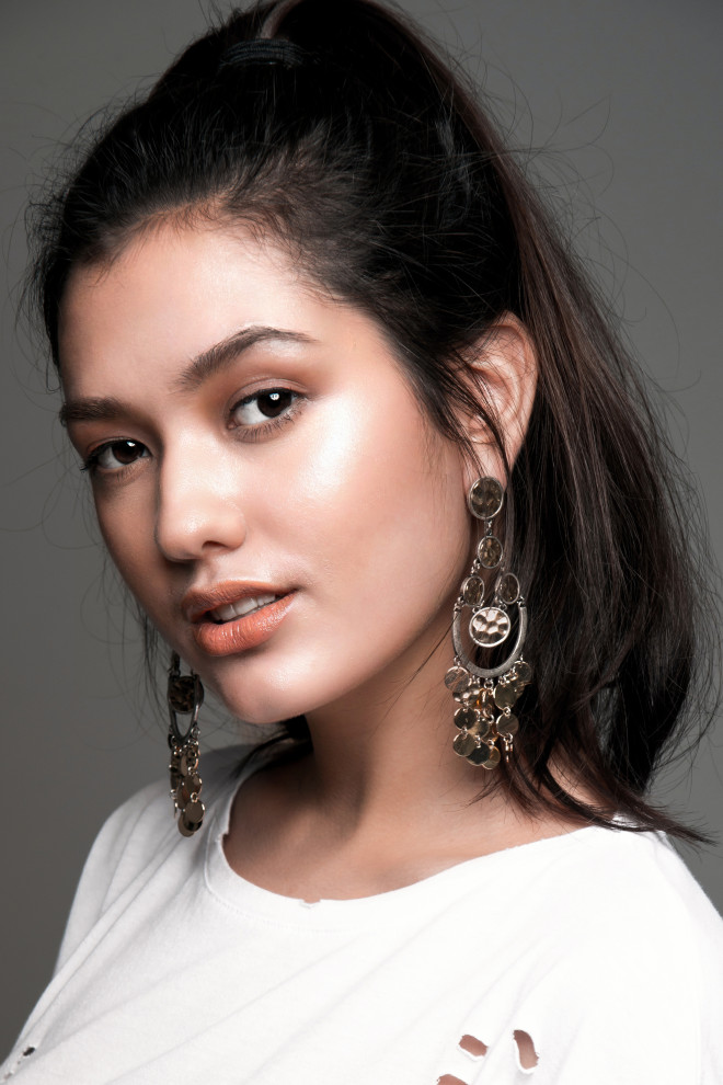 “One is a standout”  Statement earrings, Charming Charlie; distressed basic tee, Stradivarius
