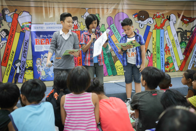 Child actors Miggs Cuaderno, Micko Laurente and Marc Justine Alvarez read to some 70 children the story "Peter and Ahmed," about a Christian and a Muslim who become best friends. Photo by John Paul R. Autor/Inquirer