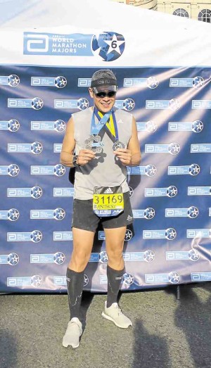 Anthony gets two medals, for the Boston Marathon and for completing six world marathons.