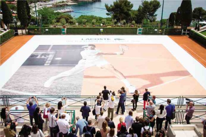 The much-bigger-than-life image of Djokovic on two clay courts is unveiled before the guests.