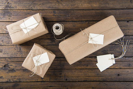 gifts for christmas packaged and wrapped on a wooden table