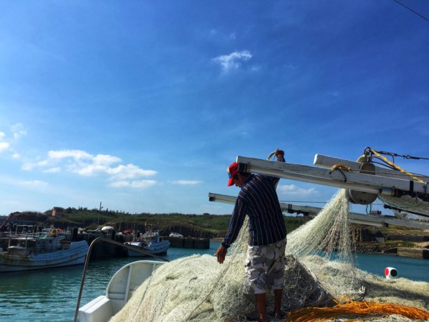 A fisherman in Beiliao village prepares his net to fish. The village is home to Penghu’s traditional fishing community. Photos by Krixia Subingsubing
