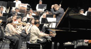 Pianist Raul Sunico performs with the Philippine Philharmonic Orchestra under musical director Yoshikazu Fukumura (right).