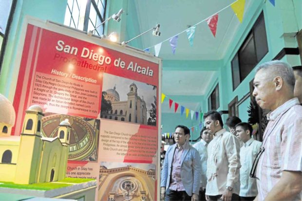 Museum goers view panel presentation on the Silay Pro-cathedral.