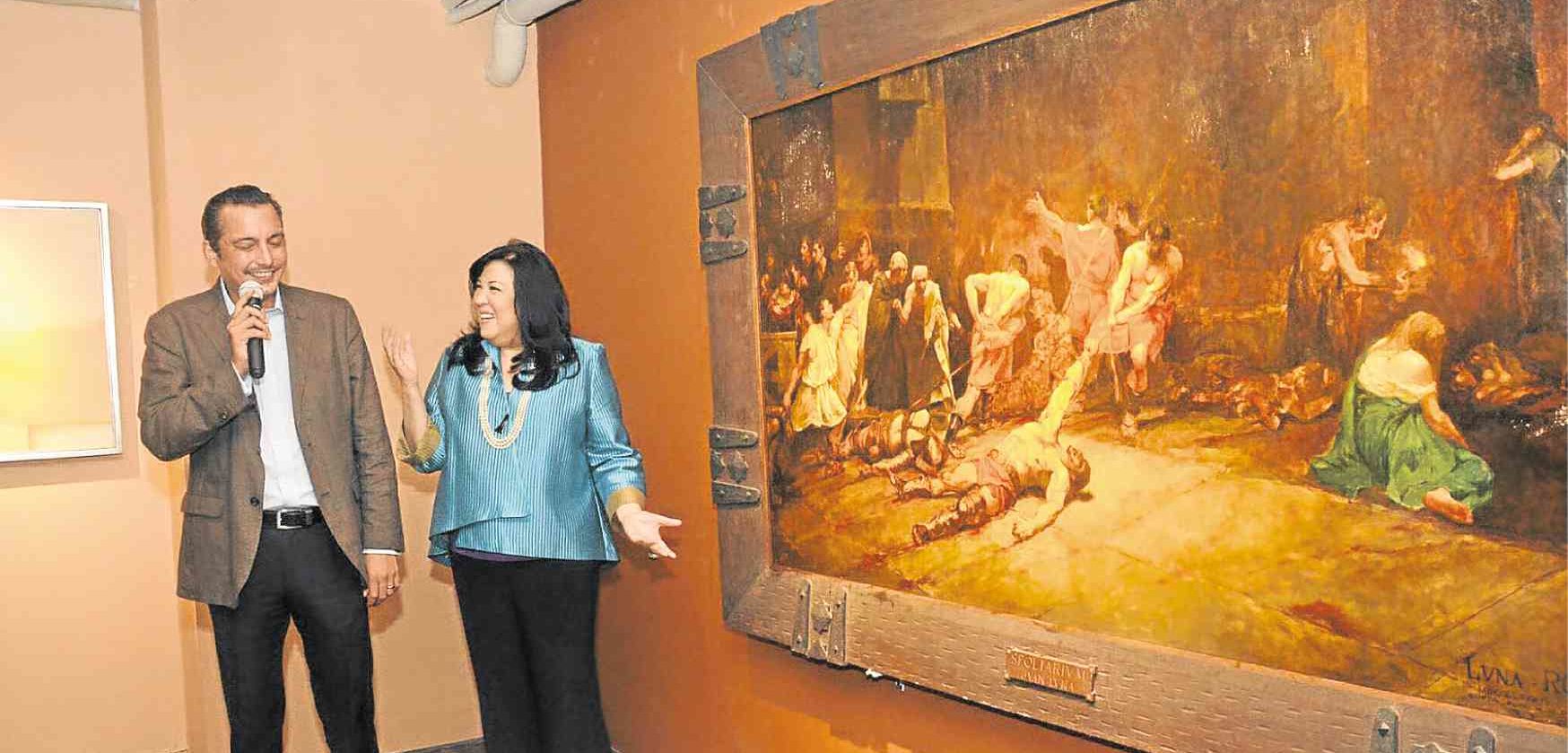 National Museum director Jeremy Barns and writer Lisa Guerrero-Nakpil unveil Antonio Dumlao’s copy of Juan Luna’s celebrated “Spoliairium” at León Gallery.
