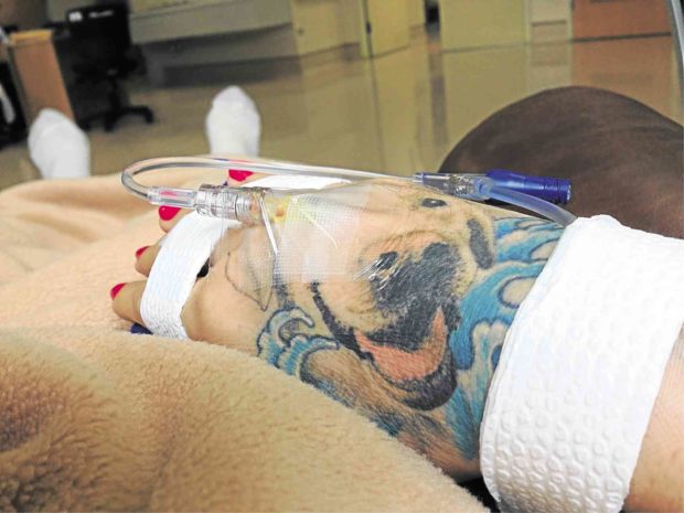 The author receives intravenous chemotherapy through her tattooed right hand in 2013.