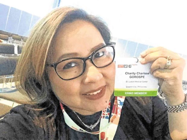Doc Charity shows off her ID at the 2018 Congress of the European Society of Medical Oncology in Munich.